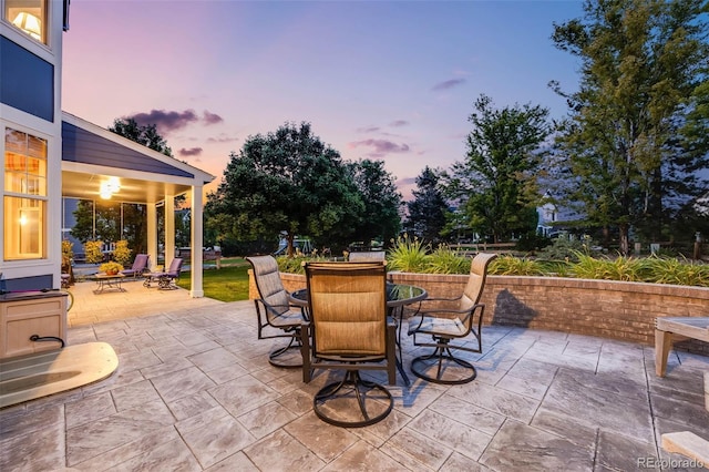 patio terrace at dusk with outdoor dining area