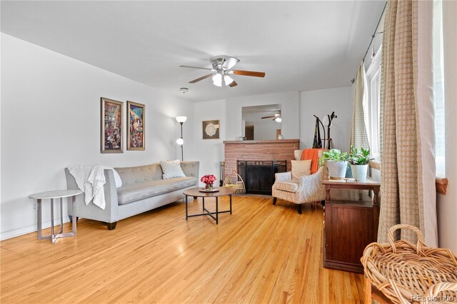 8481 E Briarwood Blvd, Centennial, CO 80112 - living room featuring ceiling fan, light wood-style flooring, and a fireplace
