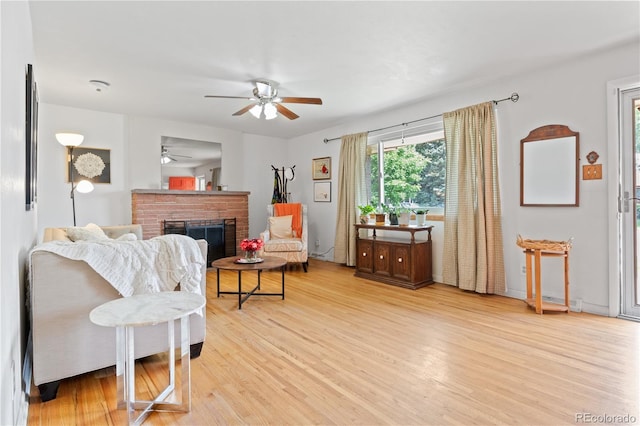 8481 E Briarwood Blvd, Centennial, CO 80112 - living area featuring ceiling fan, light wood-style flooring, and a brick fireplace