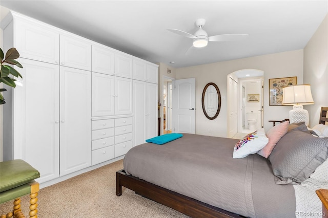 1200 N Humboldt St Unit 1003, Denver, CO 80218 - bedroom featuring light carpet, arched walkways, ensuite bath, ceiling fan, and a closet