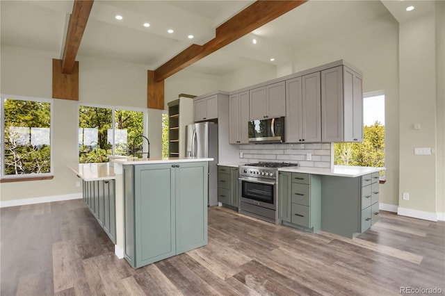 586 Alpine Way, Idaho Springs, CO 80452 - kitchen featuring appliances with stainless steel finishes, gray cabinets, beam ceiling, light countertops, and recessed lighting