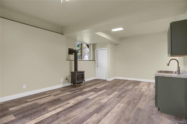 586 Alpine Way, Idaho Springs, CO 80452 - unfurnished living room featuring a wood stove and dark wood-style flooring