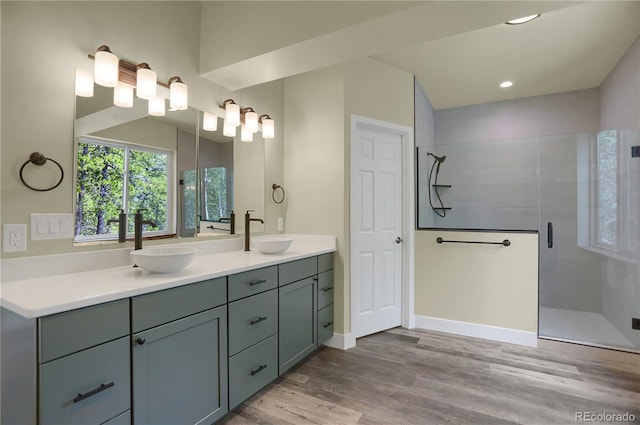 586 Alpine Way, Idaho Springs, CO 80452 - bathroom featuring double vanity, a shower stall, wood finished floors, and recessed lighting