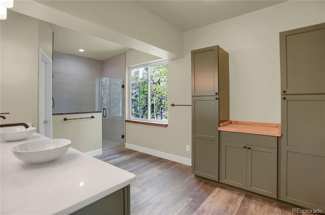 586 Alpine Way, Idaho Springs, CO 80452 - bathroom featuring wood finished floors, a shower stall, double vanity, and recessed lighting