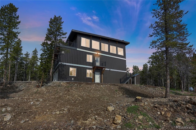 586 Alpine Way, Idaho Springs, CO 80452 - back of house at dusk with stairs and a balcony