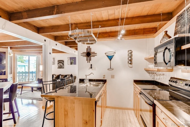 2300 Lodge Pole Cir Unit 103, Silverthorne, CO 80498 - kitchen featuring black appliances, a sink, wooden ceiling, dark countertops, and light wood-style flooring
