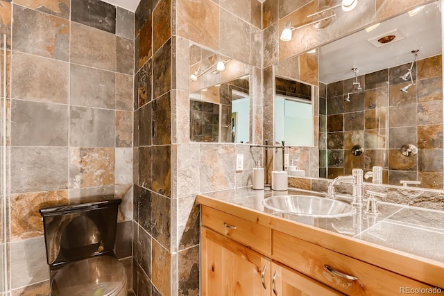 2300 Lodge Pole Cir Unit 103, Silverthorne, CO 80498 - bathroom featuring tile walls, vanity, and tiled shower