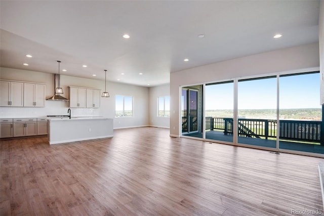 unfurnished living room with light hardwood / wood-style flooring