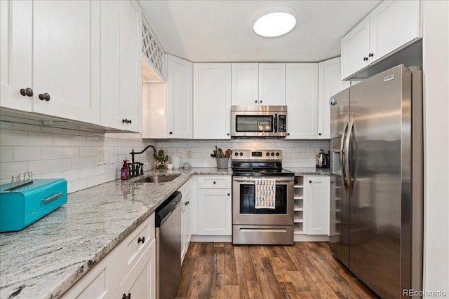 kitchen featuring dark wood-style floors, white cabinetry, stainless steel appliances, and a sink