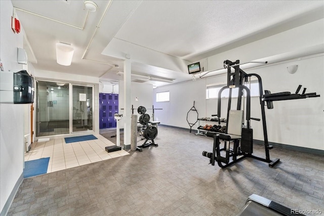 exercise room with carpet flooring and baseboards