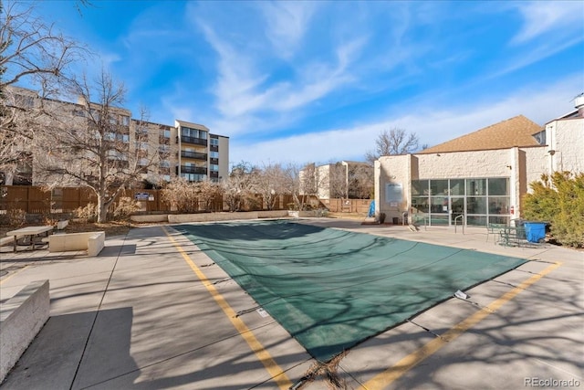 pool featuring a patio area and fence