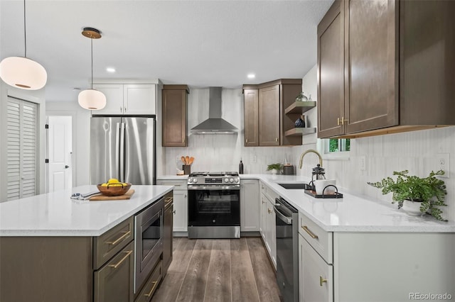 10067 W 68th Pl, Arvada, CO 80004 - kitchen with appliances with stainless steel finishes, wall chimney exhaust hood, open shelves, wood finished floors, and backsplash