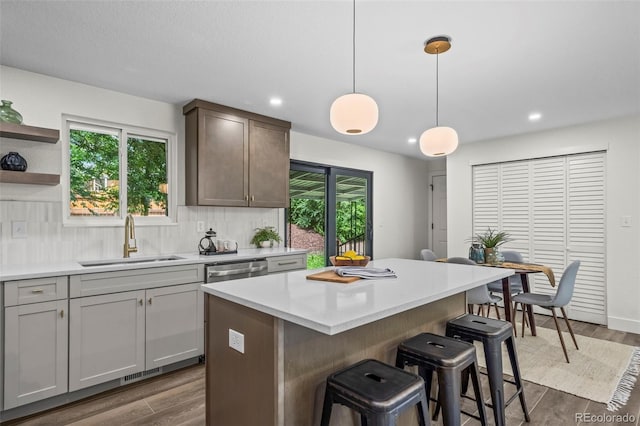 10067 W 68th Pl, Arvada, CO 80004 - kitchen with a breakfast bar area, light countertops, dark wood finished floors, plenty of natural light, and recessed lighting