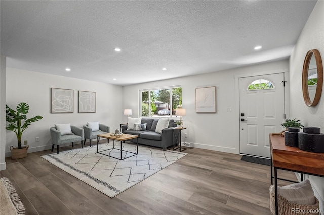 10067 W 68th Pl, Arvada, CO 80004 - living room with a textured ceiling, recessed lighting, and wood finished floors