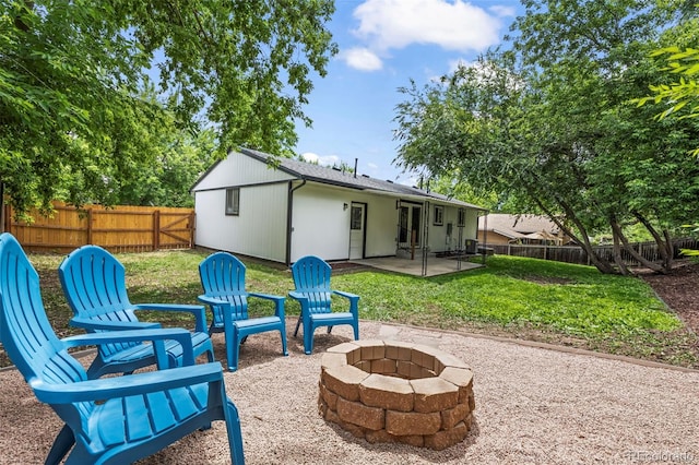 10067 W 68th Pl, Arvada, CO 80004 - rear view of house with a fire pit, a patio area, and a fenced backyard