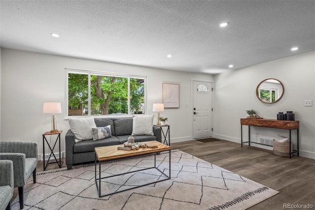 10067 W 68th Pl, Arvada, CO 80004 - living area with recessed lighting, wood finished floors, and a textured ceiling