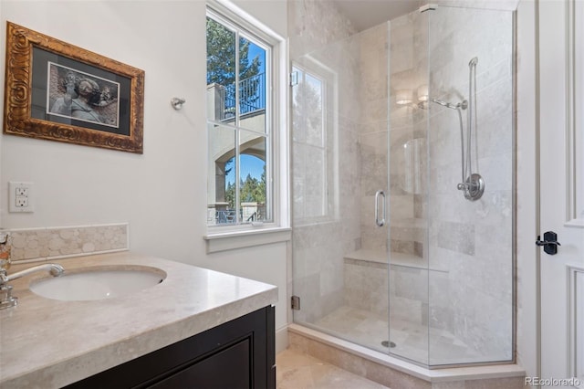 bathroom featuring a shower stall, vanity, and a healthy amount of sunlight