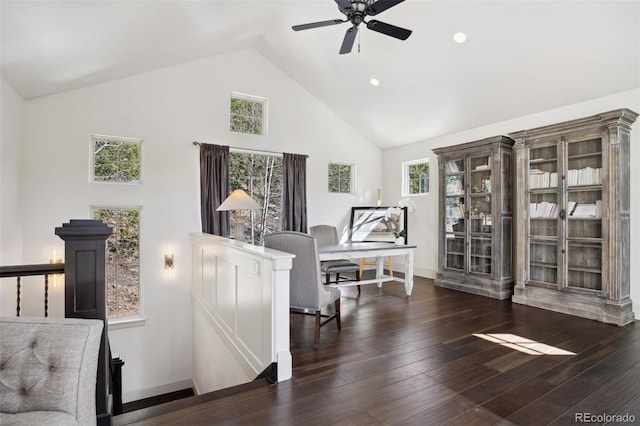 sitting room with wood finished floors, ceiling fan, baseboards, and high vaulted ceiling