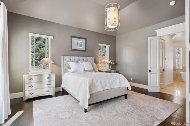 bedroom featuring baseboards and wood finished floors