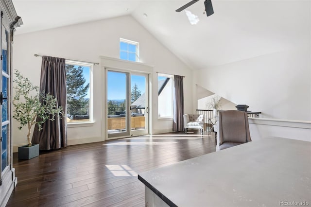 interior space with high vaulted ceiling, baseboards, a ceiling fan, and hardwood / wood-style flooring