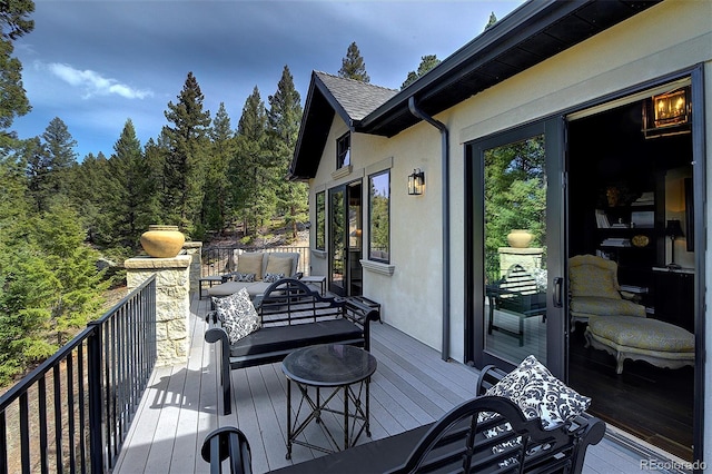 wooden terrace featuring outdoor lounge area