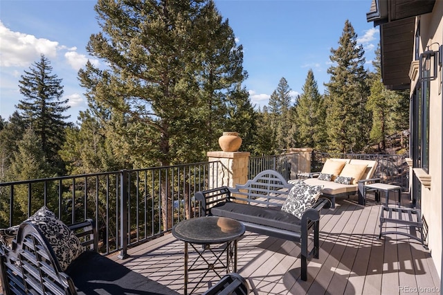 wooden terrace with an outdoor hangout area