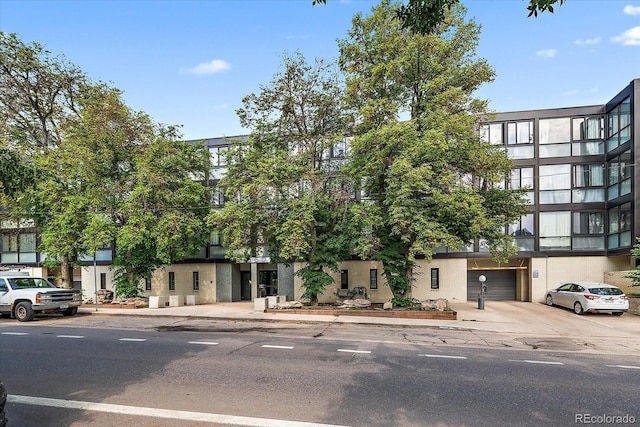 1050 N Corona St Unit 202, Denver, CO 80218 - view of building exterior with concrete driveway