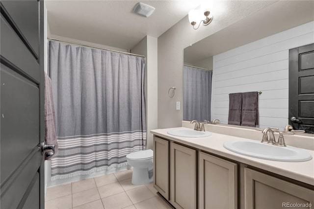 bathroom with tile patterned floors, toilet, and vanity