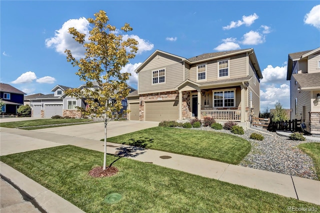 view of front of house with covered porch, a garage, stone siding, driveway, and a front lawn