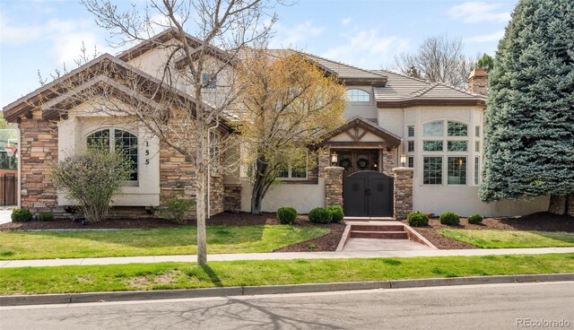 155 S Poplar St, Denver, CO 80230 - view of front of property featuring stone siding, stucco siding, and a chimney