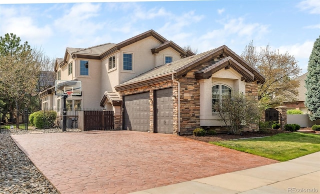 155 S Poplar St, Denver, CO 80230 - view of front facade featuring stone siding, decorative driveway, an attached garage, and stucco siding