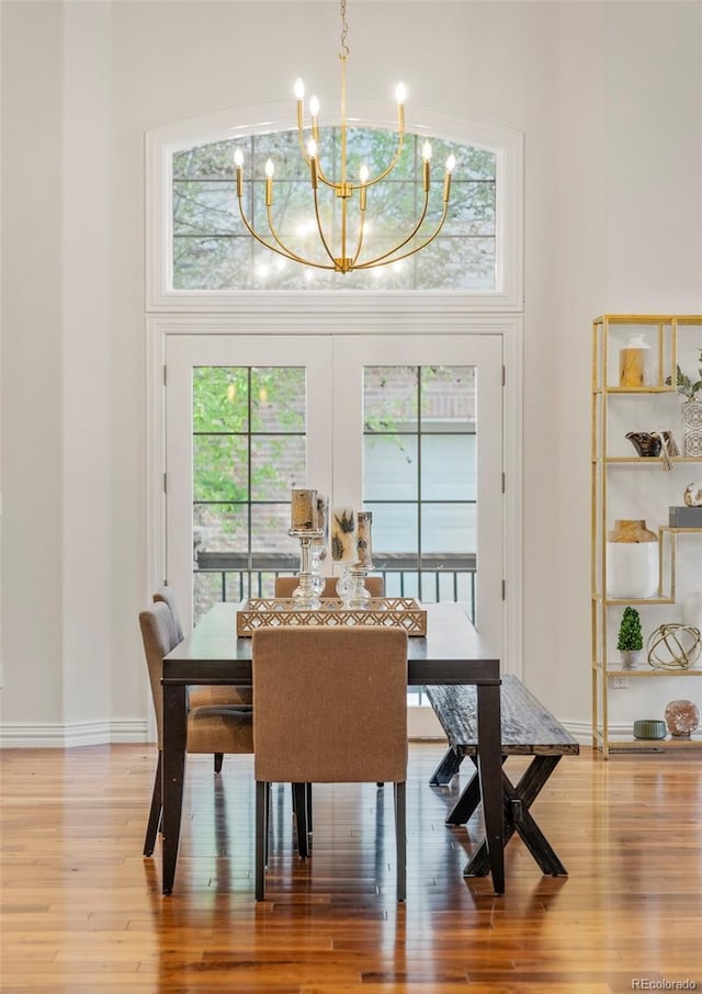 155 S Poplar St, Denver, CO 80230 - dining area with a chandelier, wood finished floors, and baseboards