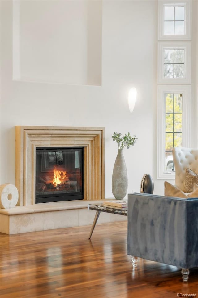 155 S Poplar St, Denver, CO 80230 - sitting room with wood finished floors, a glass covered fireplace, and a high ceiling