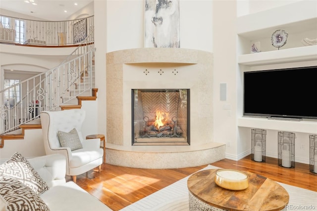 155 S Poplar St, Denver, CO 80230 - living area with wood finished floors, a premium fireplace, a high ceiling, stairs, and built in features
