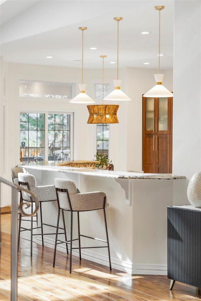 155 S Poplar St, Denver, CO 80230 - bar area with light wood-type flooring, pendant lighting, recessed lighting, and baseboards