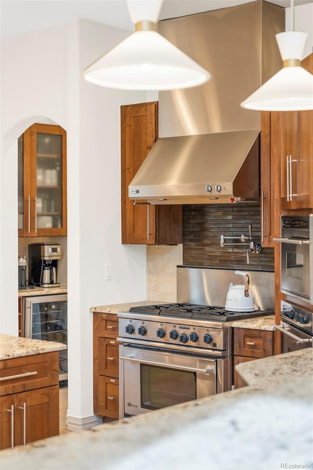 155 S Poplar St, Denver, CO 80230 - kitchen with stainless steel appliances, brown cabinets, wine cooler, decorative backsplash, and glass insert cabinets