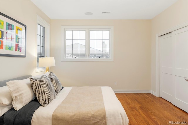 155 S Poplar St, Denver, CO 80230 - bedroom with wood finished floors, baseboards, and a closet