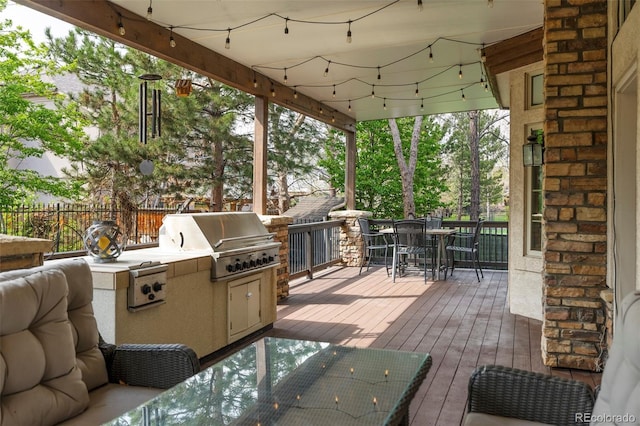 155 S Poplar St, Denver, CO 80230 - wooden deck with grilling area, outdoor dining area, an outdoor kitchen, and fence