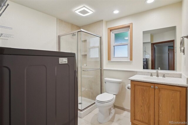 5612 S Jebel Way, Centennial, CO 80015 - bathroom with toilet, vanity, a shower stall, tile patterned flooring, and recessed lighting