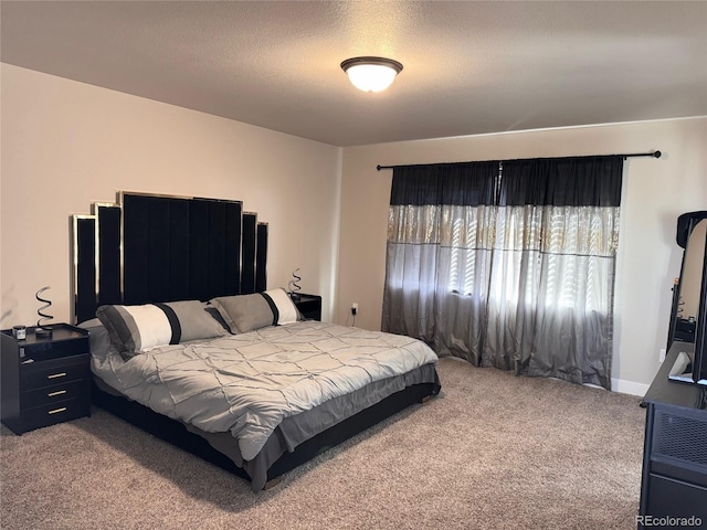 bedroom with carpet flooring and a textured ceiling