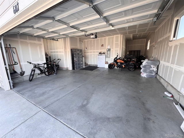 garage featuring electric panel and a garage door opener