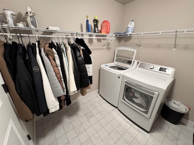 laundry area with washer and dryer, baseboards, and laundry area