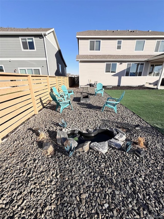 view of yard featuring a fire pit and a fenced backyard