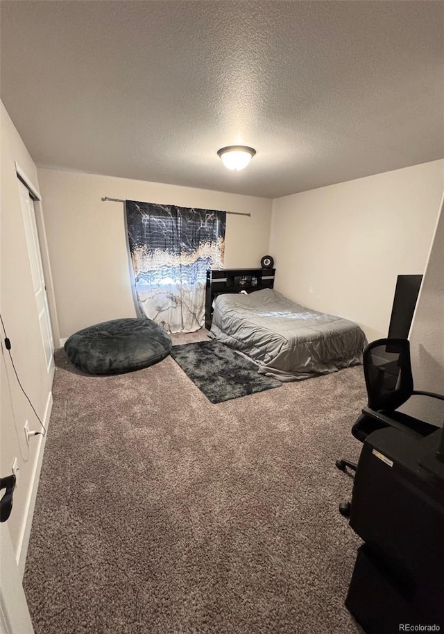 carpeted bedroom featuring a textured ceiling