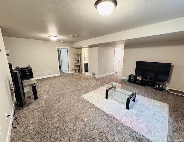 exercise room with visible vents, baseboards, a textured ceiling, and carpet flooring