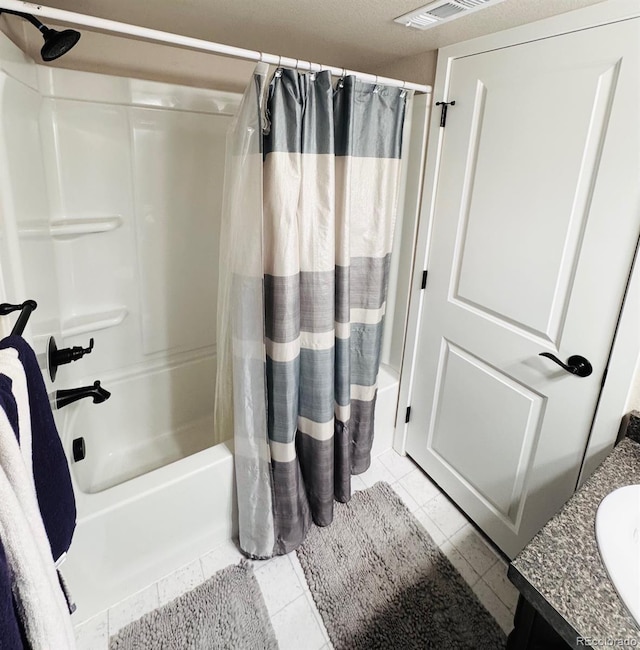 bathroom with vanity, tile patterned floors, visible vents, and shower / tub combo with curtain