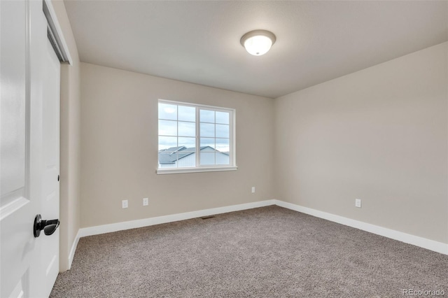 unfurnished room featuring carpet floors, baseboards, and visible vents
