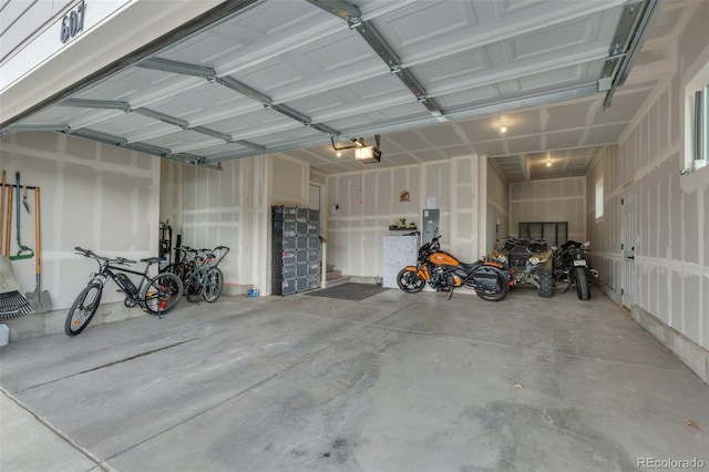 garage with a garage door opener and electric panel