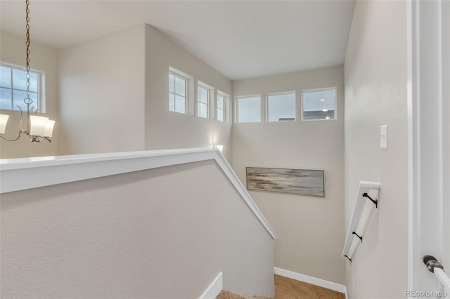 staircase with baseboards and carpet