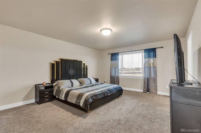 carpeted bedroom featuring baseboards